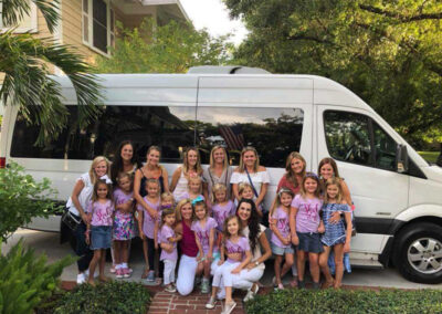 Kids party in front of white bus