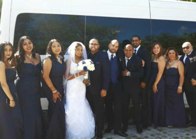 Wedding party in front of party bus